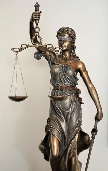 Lady Justice Lady Justice: A statue of a blindfolded woman holding a scale and a sword.